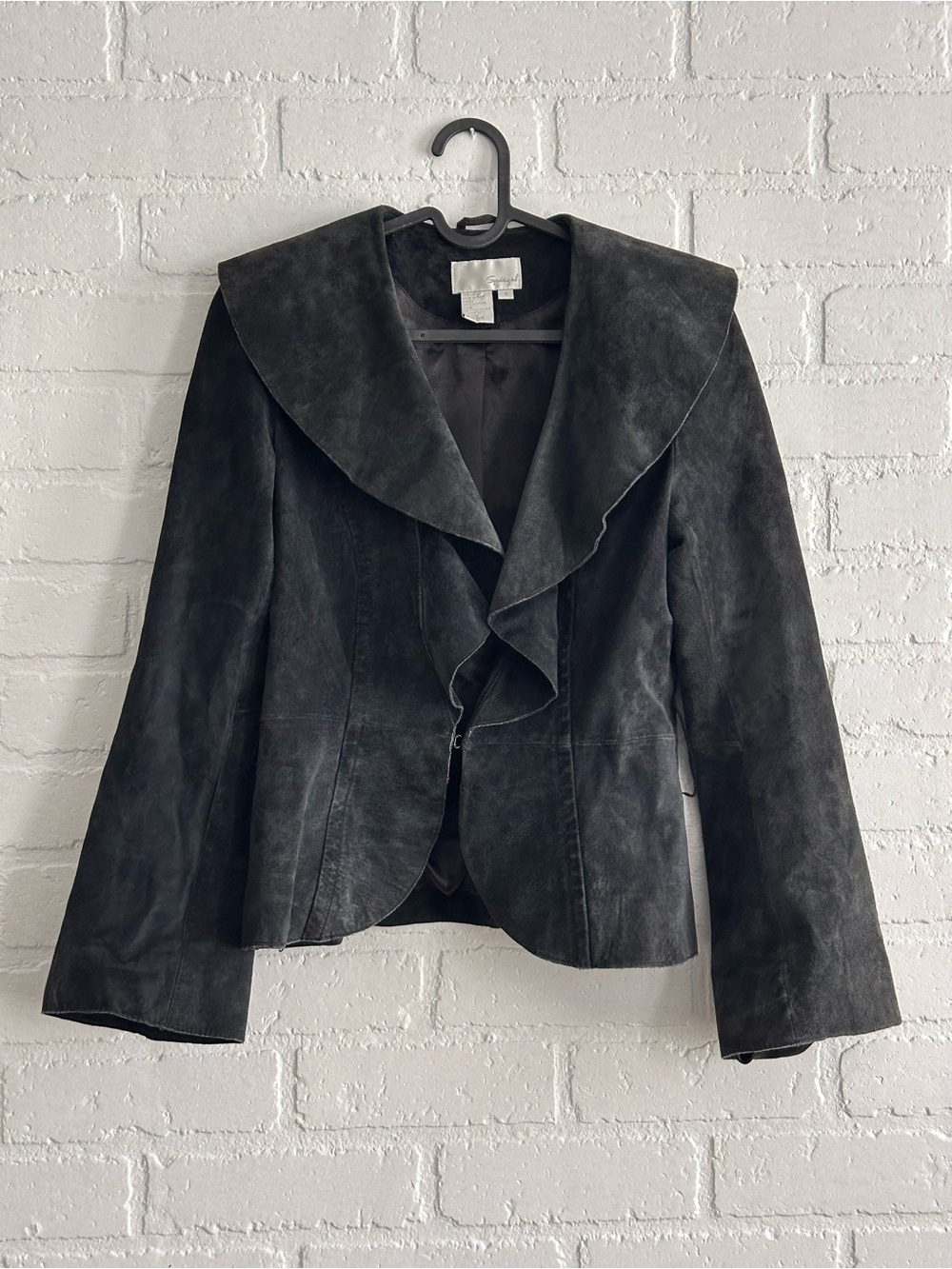 Black suede 100% leather jacket with ruffle collar and bell sleeves.